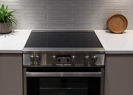 A modern stainless steel oven and cooktop.